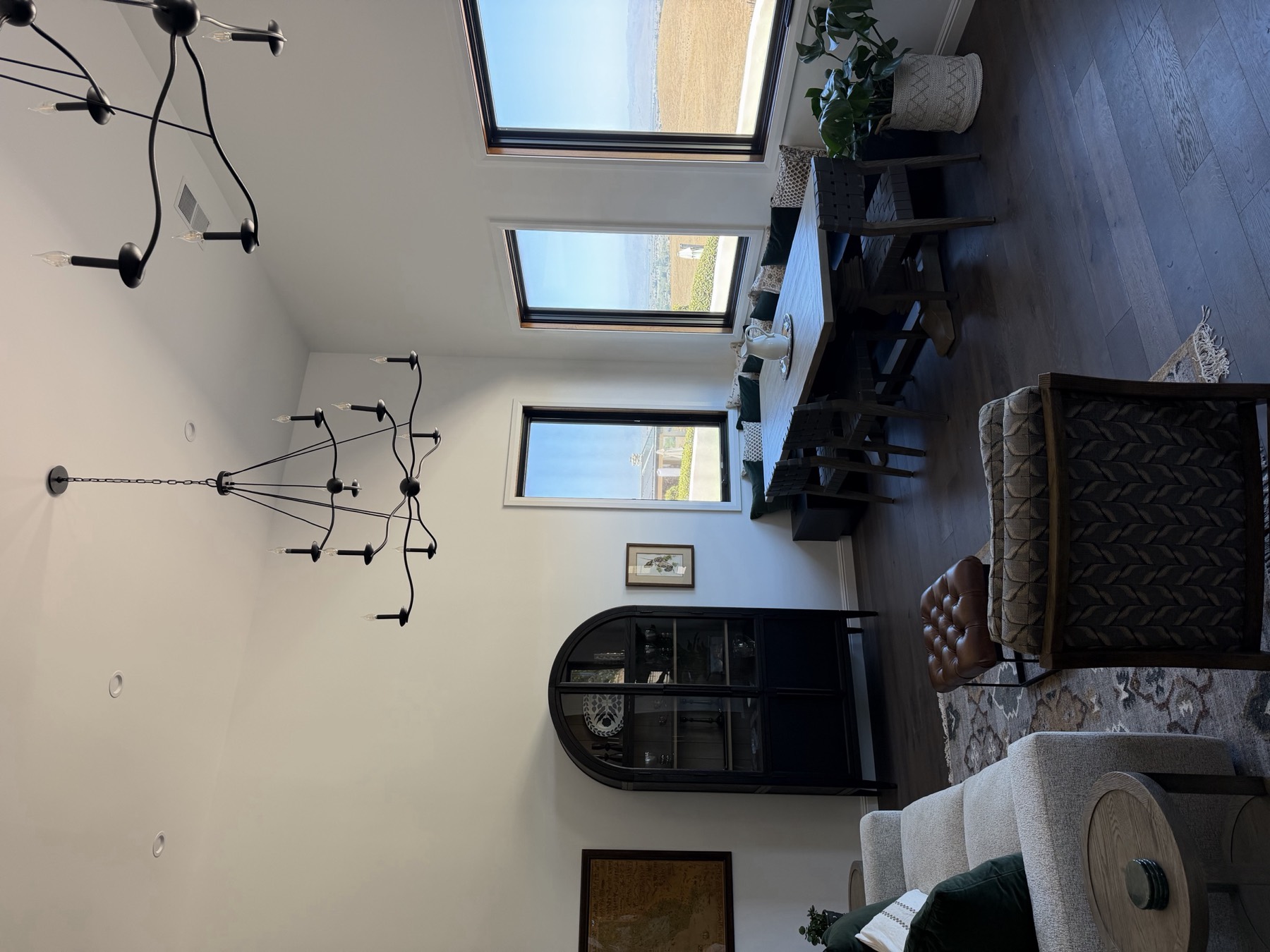The great room the built-ins had to live up to — vaulted ceiling, dark wide-plank floors and full-height windows onto the valley.